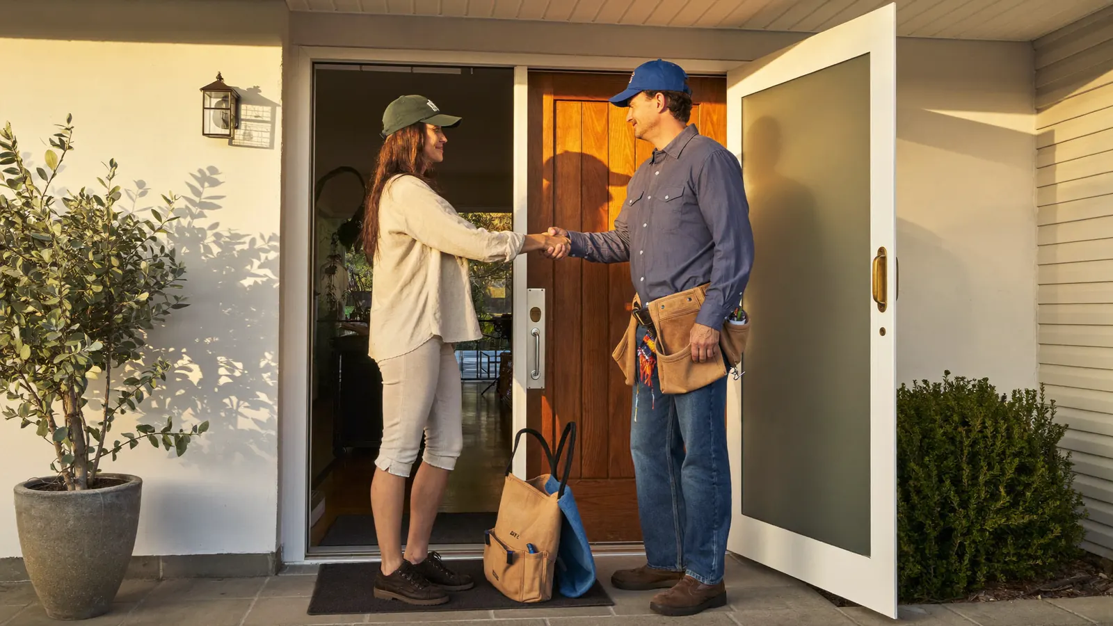 Adelaide homeowner welcoming a licensed electrician at the door