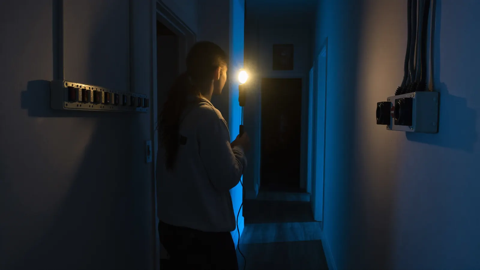 Checking the Australian switchboard by torchlight during an Adelaide power outage