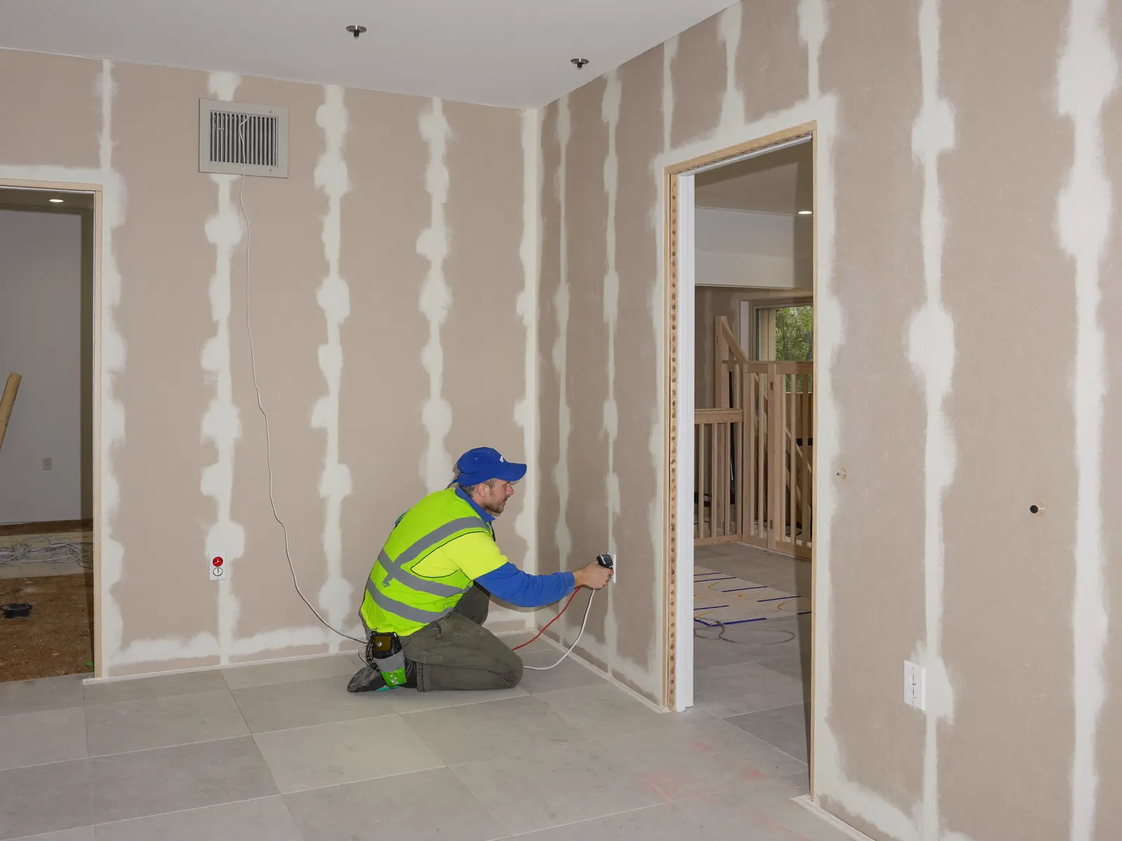 Electrician installing switch plates and power points at fit-off stage in an Adelaide new-build